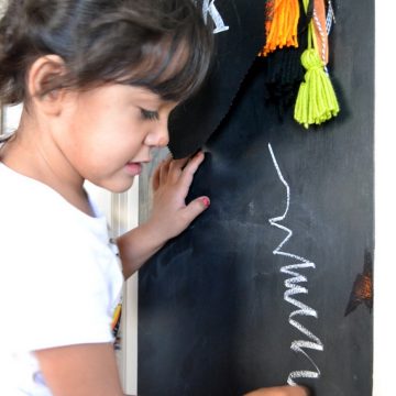 Use a chalkboard door to create and art center for kids on seelindsay.com