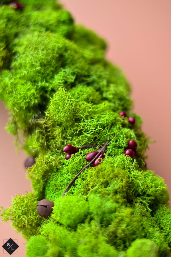 Create an easy farmhouse Christmas wreath using moss and wire garland