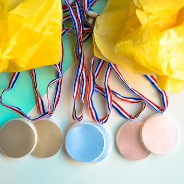 Create these DIY Olympic Medals. The perfect kids craft to celebrate the excitement of the Olympics.