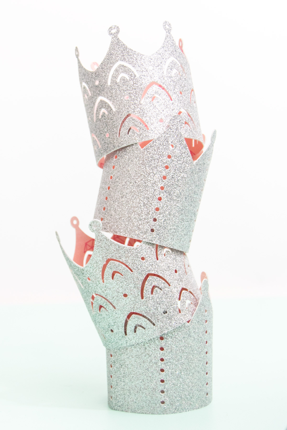 Create the perfect princess party crowns by using glitter cardstock and coordinating patterned paper. Get all the details on the blog. #princessparty #princesspartyideas #diypapercrown #cricut #cricutmade