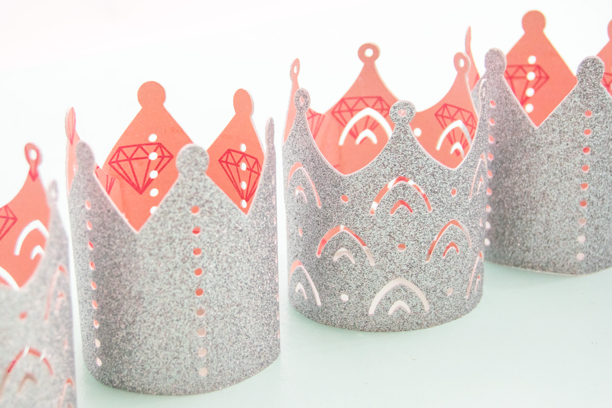 Create the perfect princess party crowns by using glitter cardstock and coordinating patterned paper. Get all the details on the blog. #princessparty #princesspartyideas #diypapercrown #cricut #cricutmade