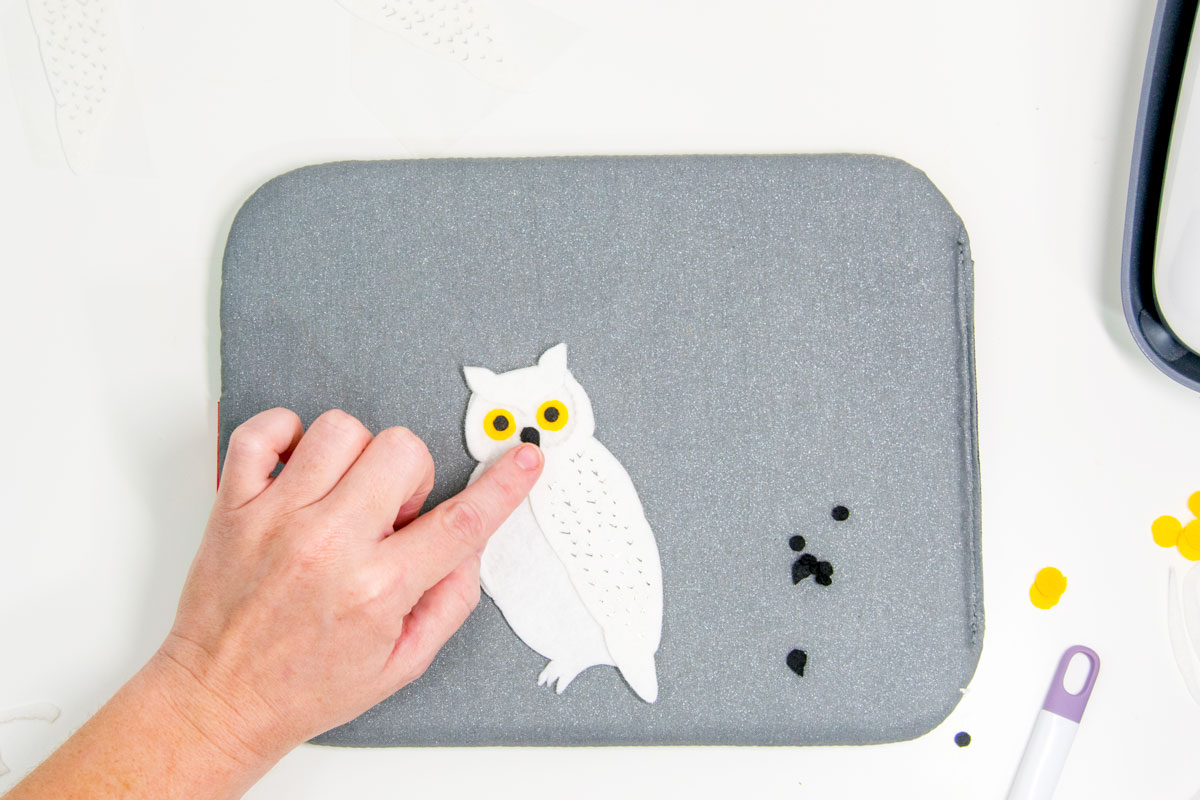 gluing the beak to a felt owl