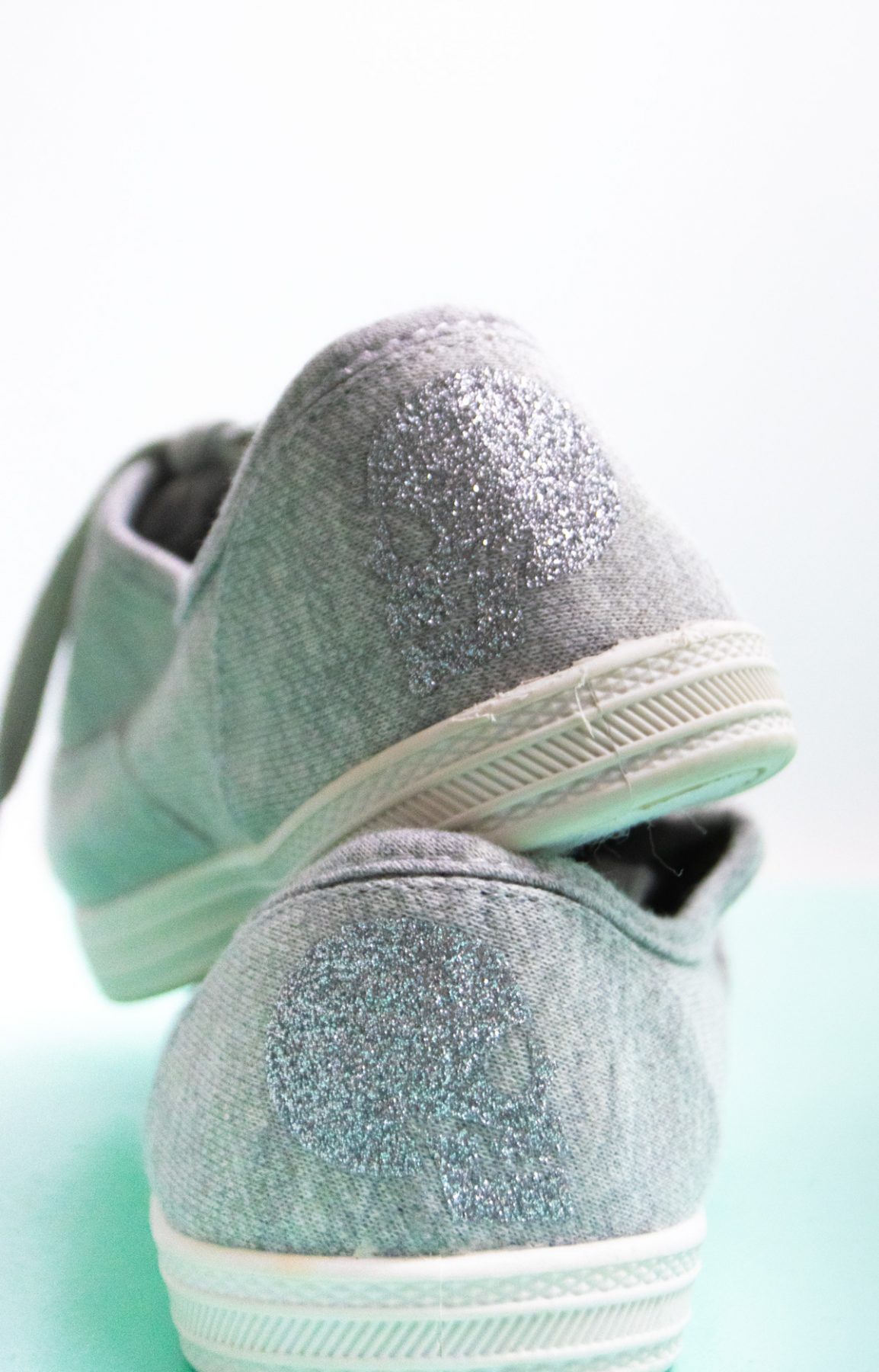 grey shoes with skeleton on the back
