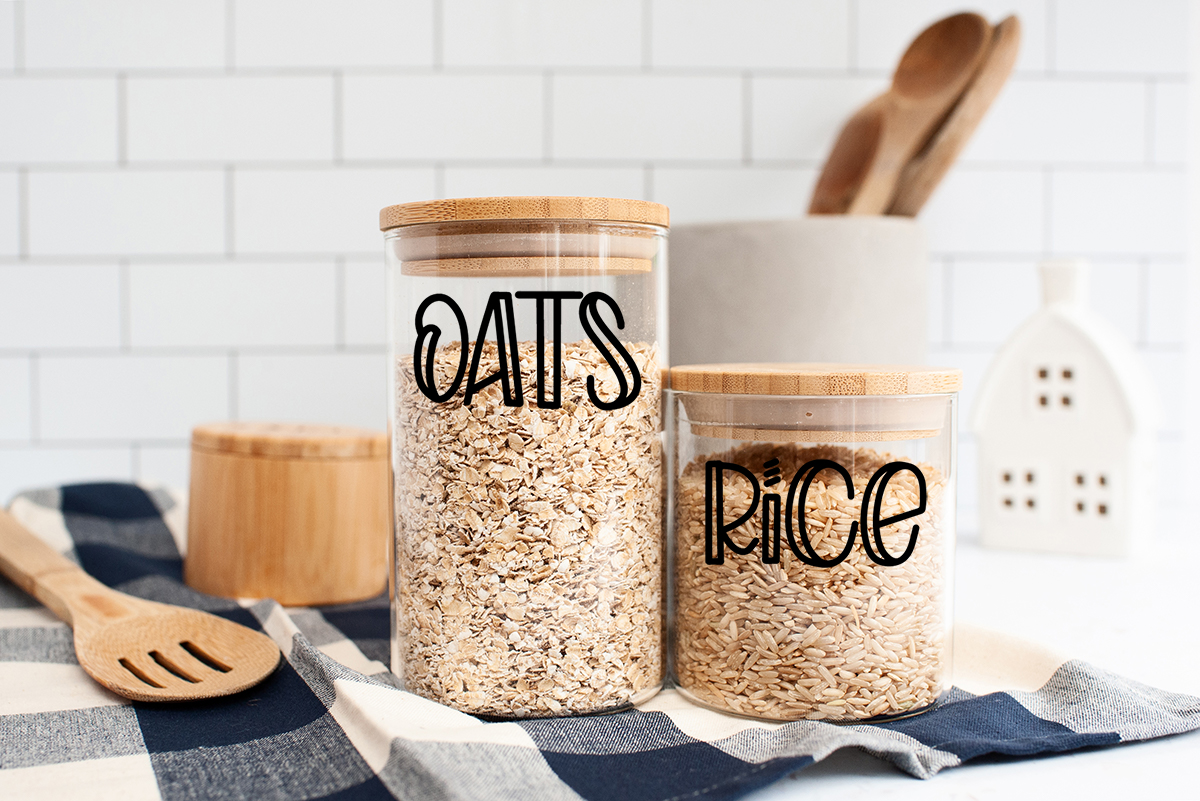 jars on counter filled with oats and rice with labels
