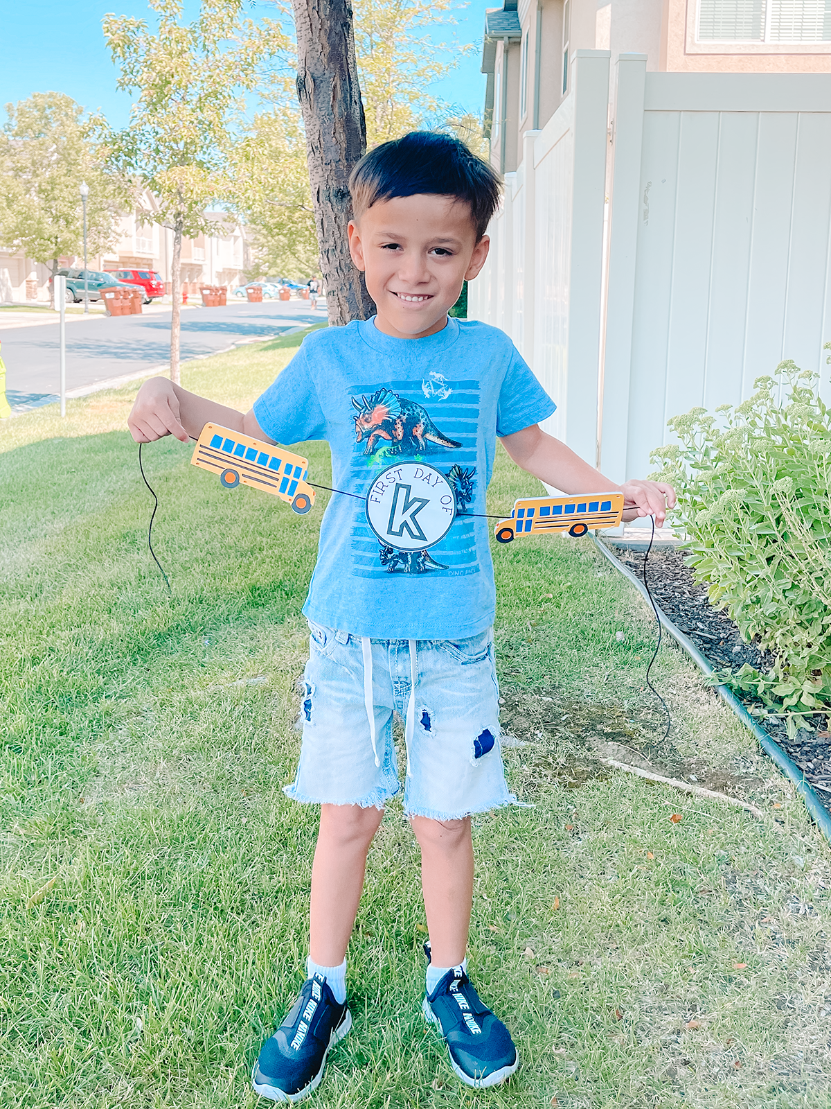 boy holding back to school banner made with the cricut